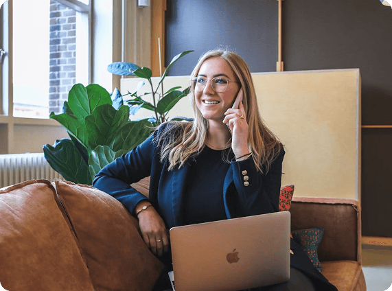 Person working flexibly with laptop and plants